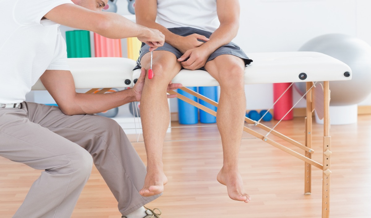 Doctor Checking Knee Of A Patient