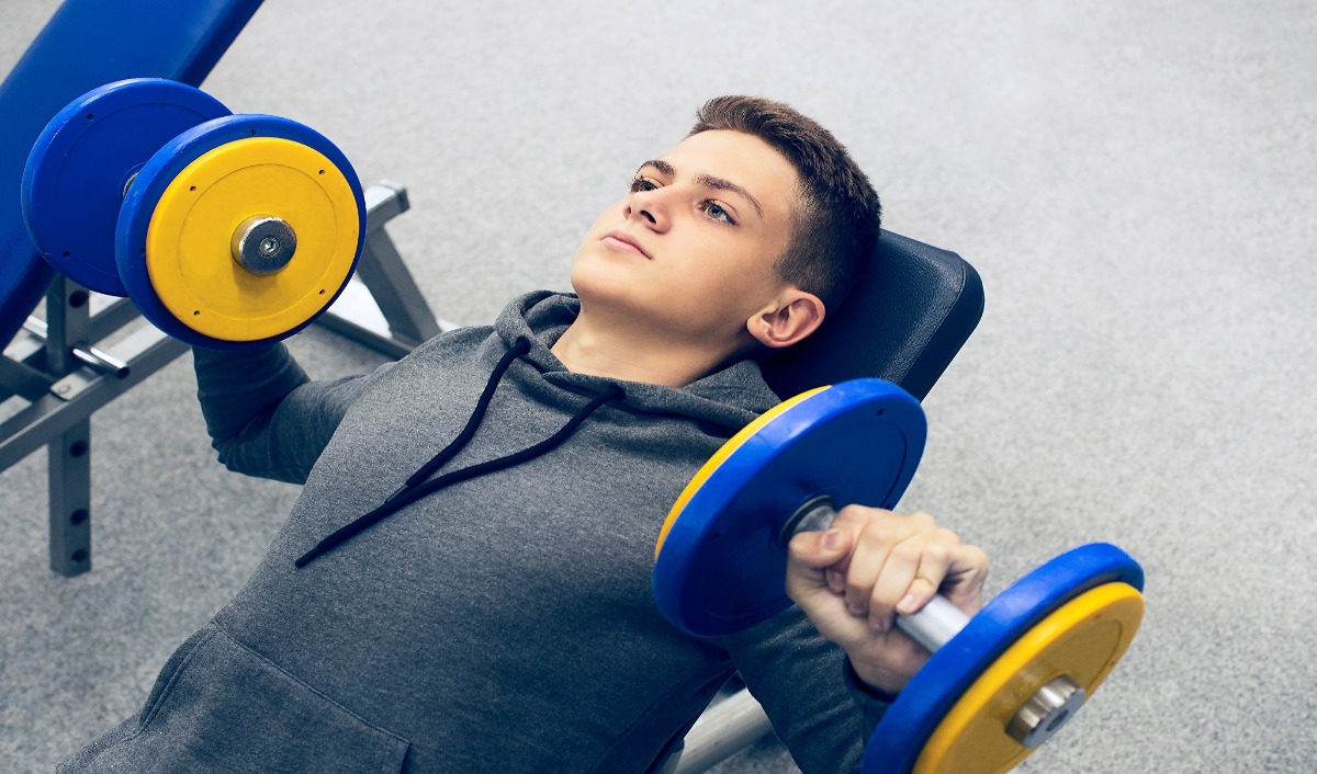 Kids lighting weights in gym